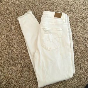 All white jeans. Slight rips in the front.